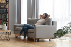 woman-leaning-back-on-couch-looking-comfortable