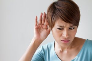 person-listening-to-the-sounds-their-air-conditioner-makes