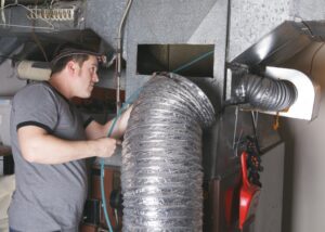 HVAC-technician-performing-duct-cleaning