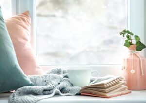 a-cozy-winter-scene-with-teacup-and-book-and-wintry-view-out-the-window