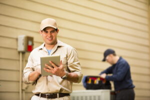 HVAC-technicians-working-on-a-heat-pump-outdoor-unit